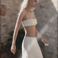 Woman wearing a beige crop top with matching linen maxi skirt