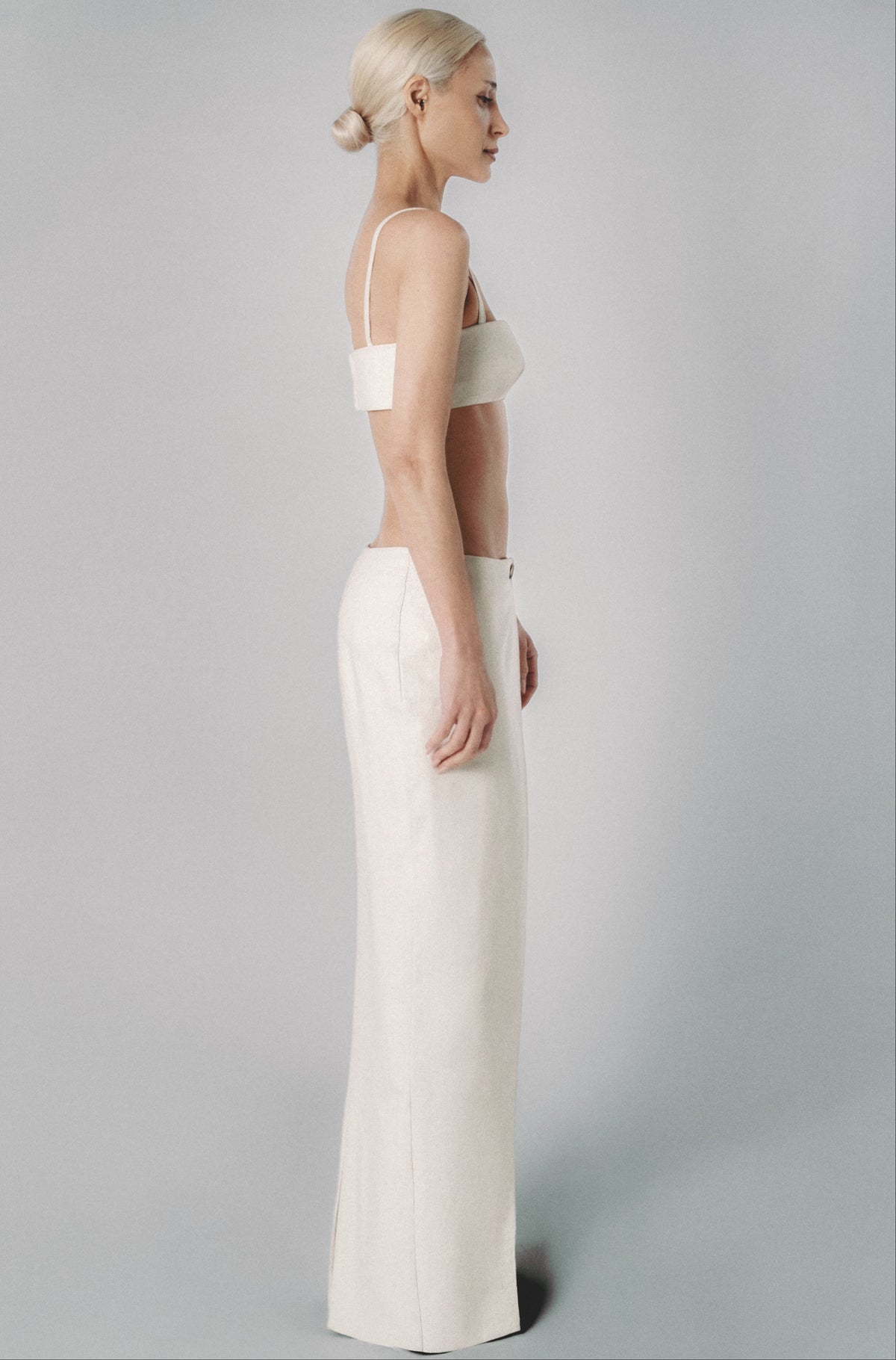 Beige low-rise maxi skirt styled with a matching bra crop top for a two-piece summer outfit