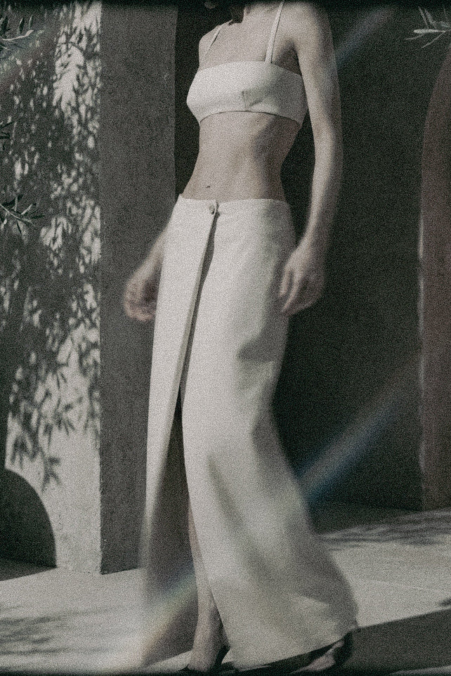 Beige low-rise maxi skirt styled with a matching bra crop top for a two-piece summer outfit