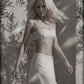 Woman wearing a beige low-waist linen cotton maxi skirt with matching bra crop top