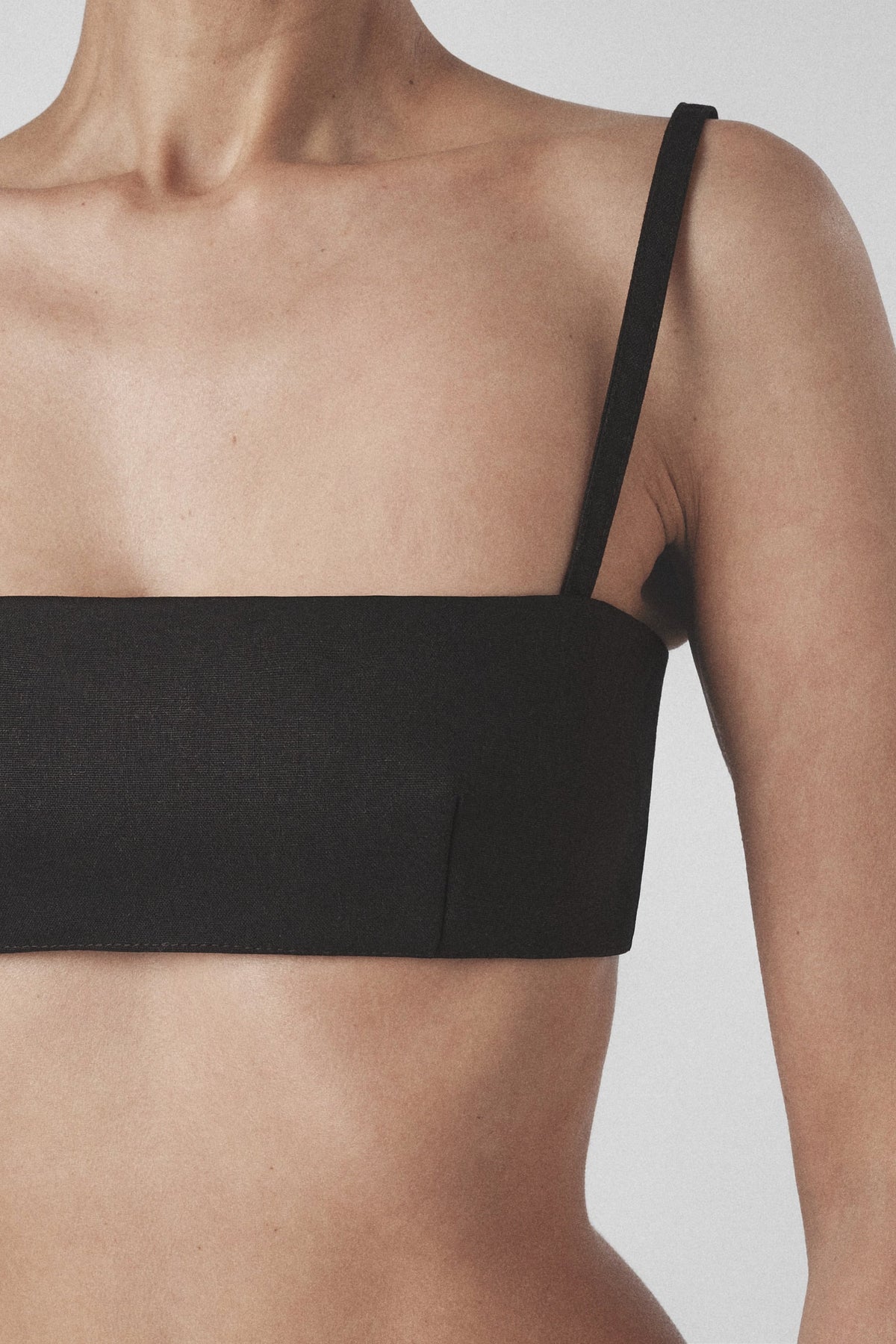 Close-up front view of the Black bra crop top with straight neckline and slim straps