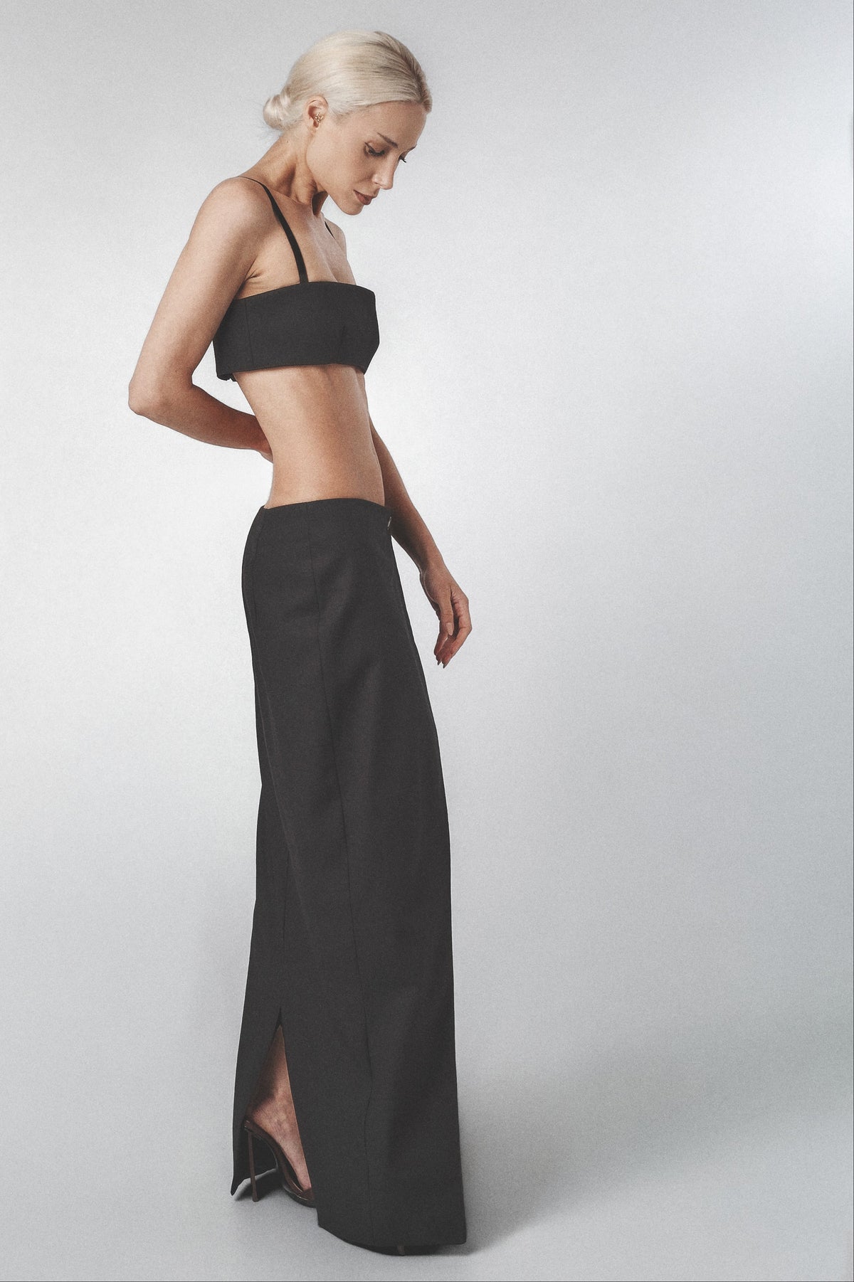 Black bra top styled with the matching low-waist linen maxi skirt