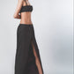 Woman wearing a Black crop top with matching full-length maxi skirt
