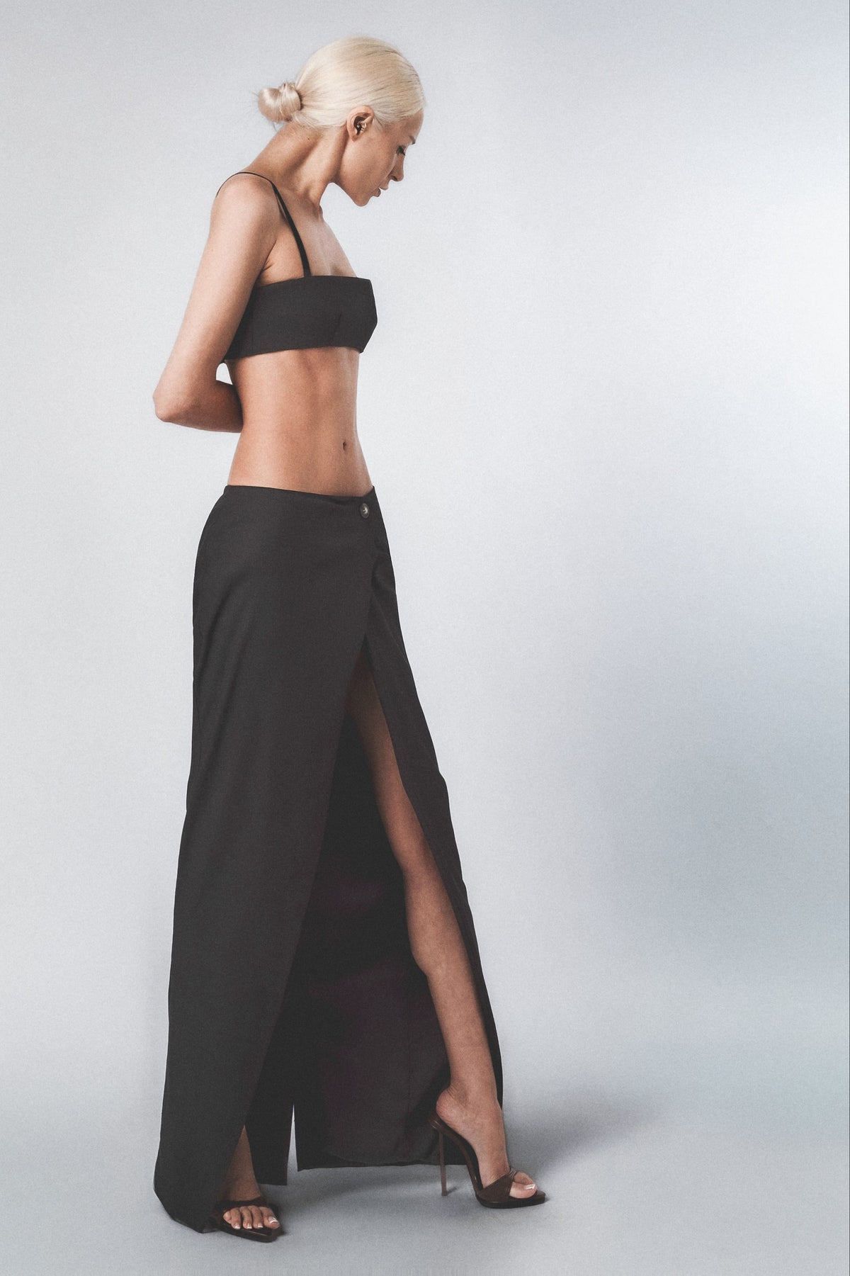 Woman wearing a Black crop top with matching full-length maxi skirt