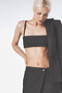 Woman wearing the Black linen bra crop top with matching low-waist maxi skirt