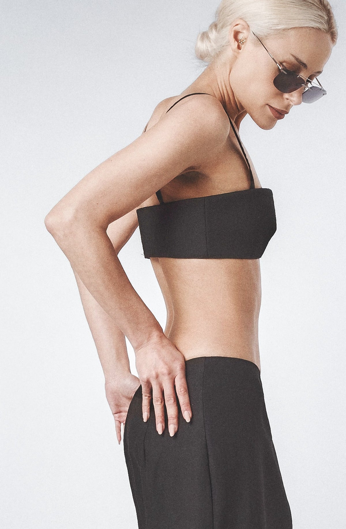 Side profile of the Black linen bra top showing its close structured fit