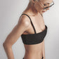 Side view of the Black linen cotton crop top showing its close structured fit