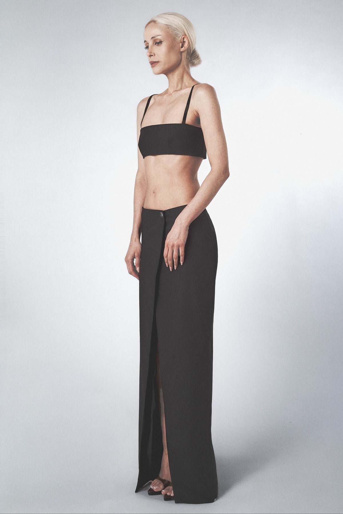Woman wearing a Black low-rise maxi skirt with a straight full-length cut