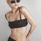 Woman wearing a Black structured bra crop top with slim straps