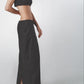 Black structured maxi skirt worn low on the waist with matching bra top