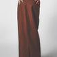 Side view of the brown low-rise maxi skirt showing its straight full-length cut