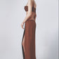 Woman wearing a brown low-waist linen maxi skirt with matching crop top