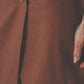 Close-up of the brown low-waist maxi skirt showing the front closure and linen cotton fabric