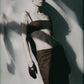 Woman wearing the Cacao brown bra crop top with matching maxi skirt in an editorial image