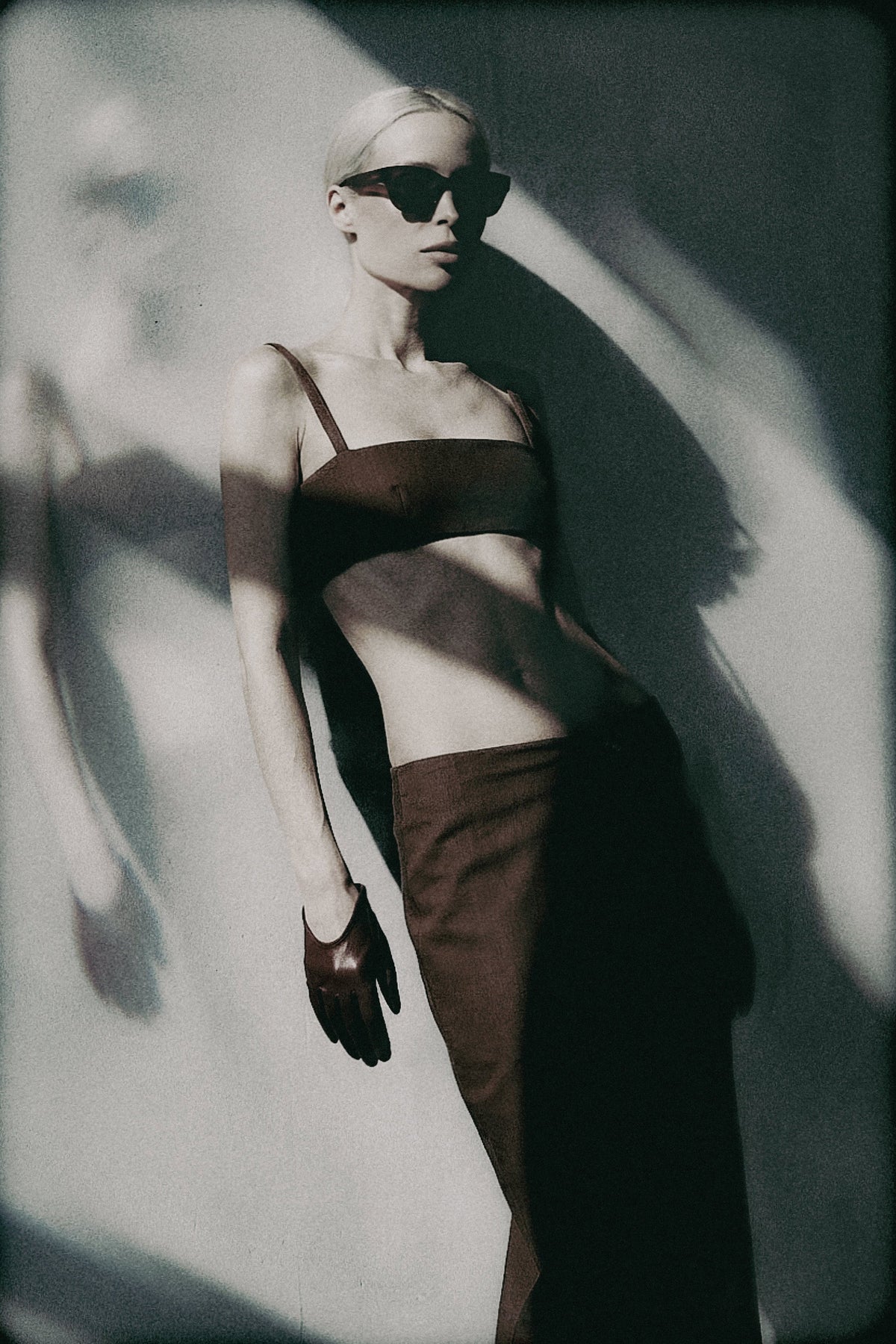 Woman wearing the Cacao brown bra crop top with matching maxi skirt in an editorial image