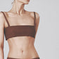 Woman wearing the Cacao brown linen bra crop top with matching low-waist maxi skirt