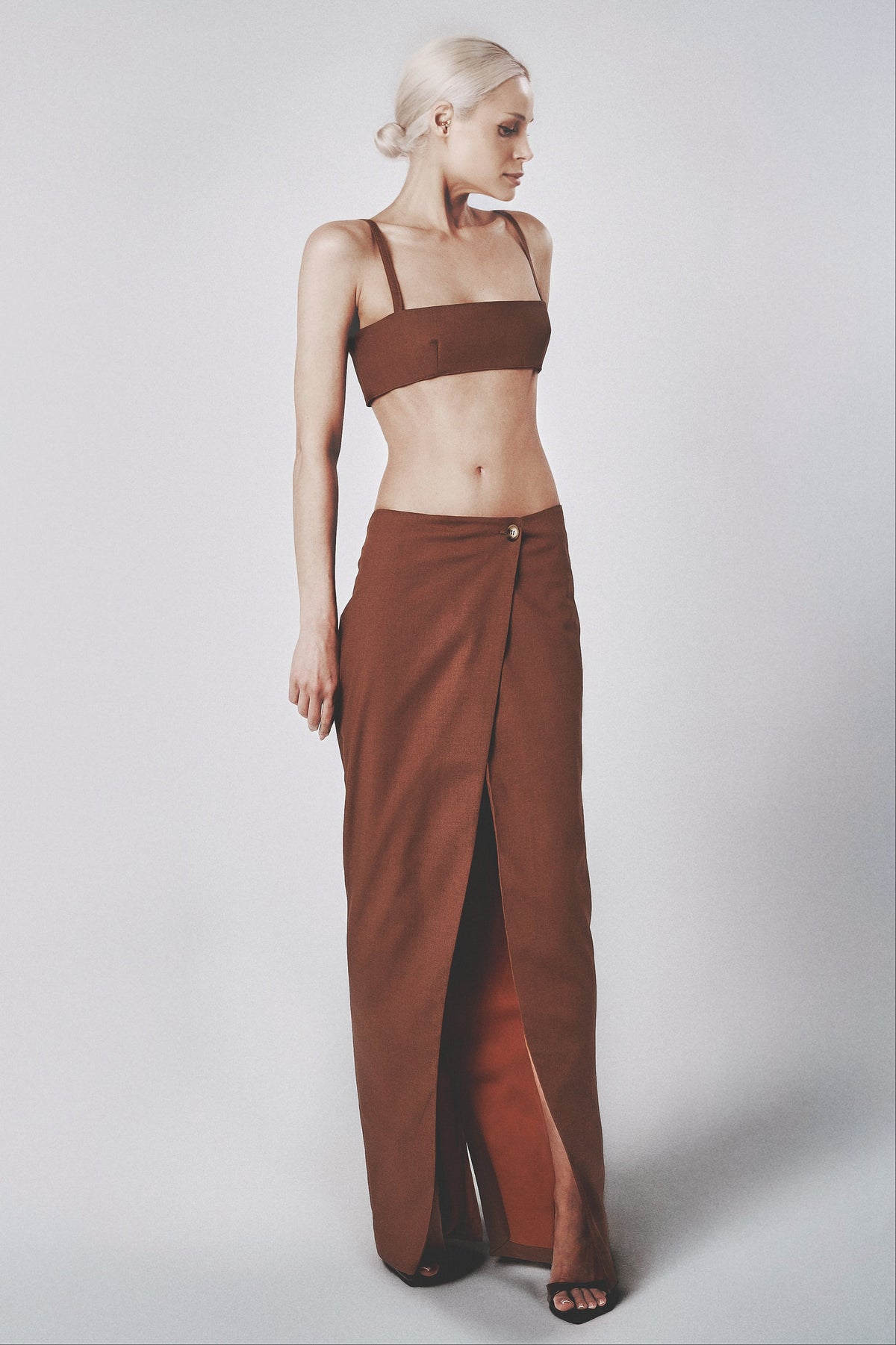Woman wearing the Cacao brown linen cotton maxi skirt with matching bra crop top