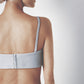 Side profile of the light blue linen bra crop top showing its close fit