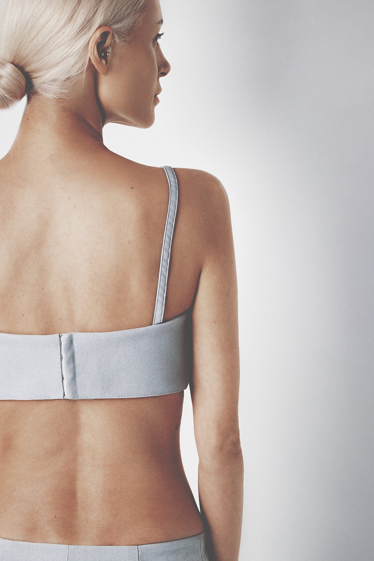 Side profile of the light blue linen bra crop top showing its close fit