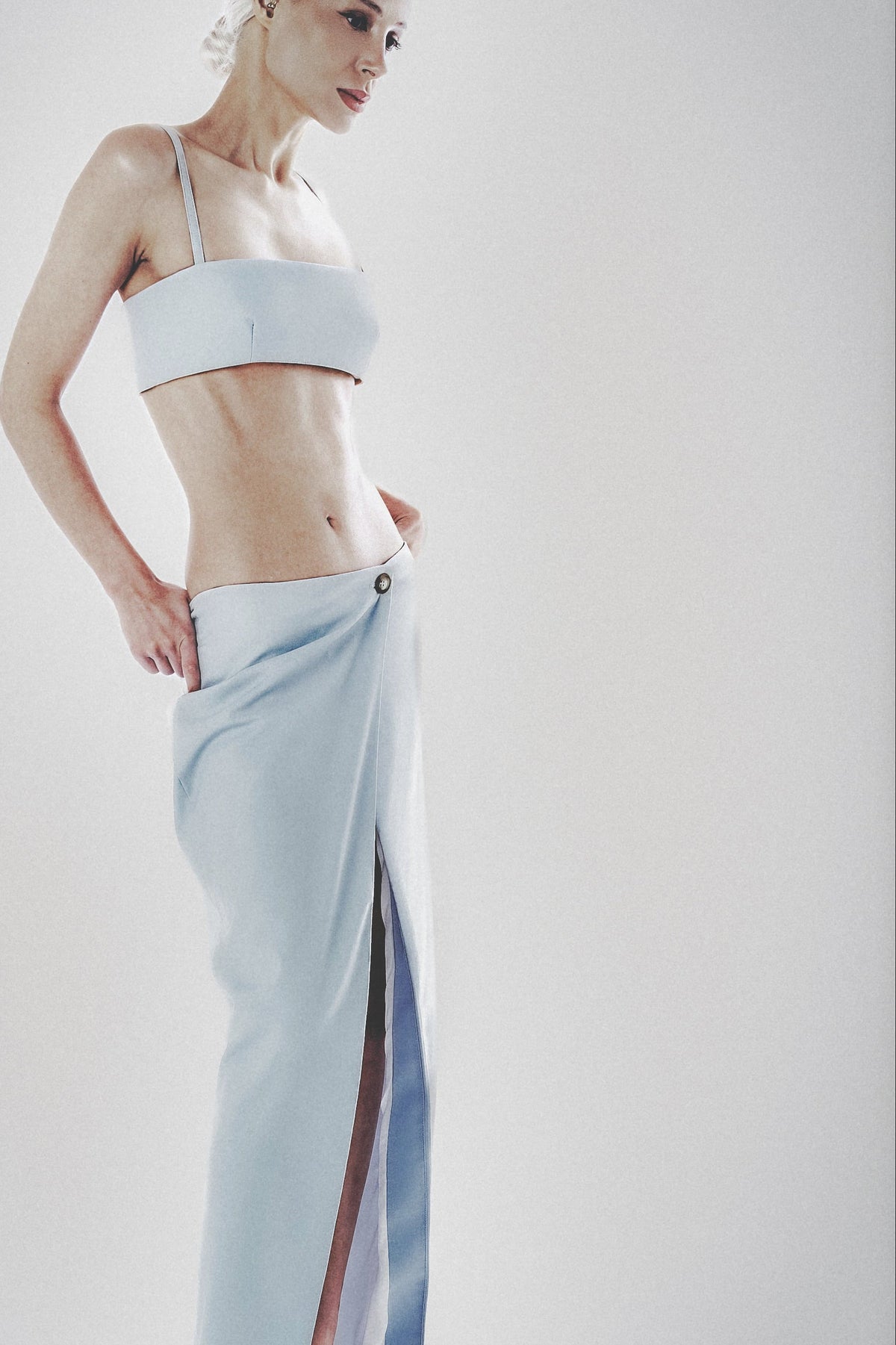 Side profile of a light blue linen cotton maxi skirt with matching crop top