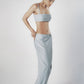 Woman wearing a light blue structured bra crop top with slim straps
