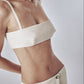 Woman wearing a structured Sand beige bra crop top with slim straps