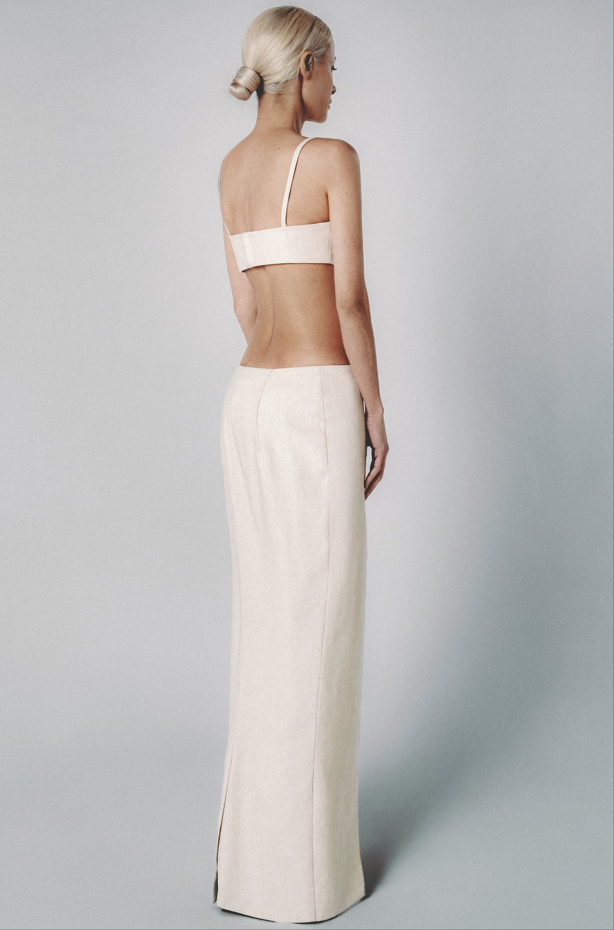 Woman wearing a Sand linen cotton maxi skirt and matching cropped bra top