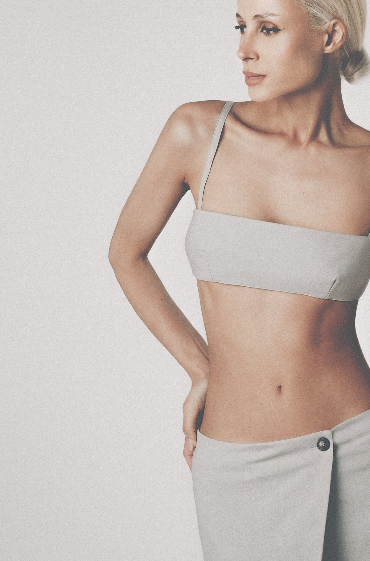 Woman wearing the Silver light grey linen bra crop top with matching low-waist maxi skirt