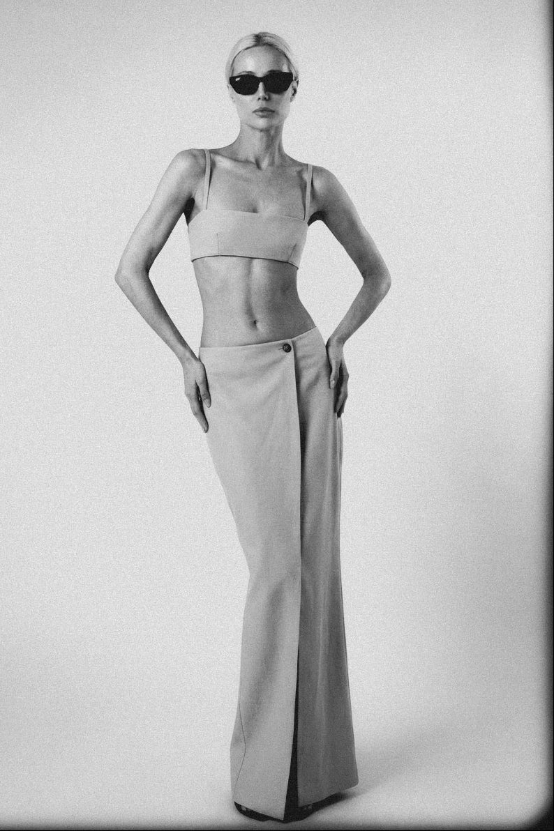Woman wearing the Silver structured bra crop top with matching maxi skirt in an editorial image