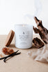 White Amber and Musk scented soy blend candle in a white glass vessel by sý ave nüe