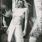 Woman wearing a White bra crop top and matching maxi skirt in an editorial image