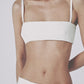 White bra top styled with the matching low-waist linen maxi skirt
