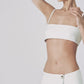 Woman wearing the White linen bra crop top with matching low-waist maxi skirt