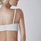 Side profile of the White linen bra top showing its close fit and slim straps