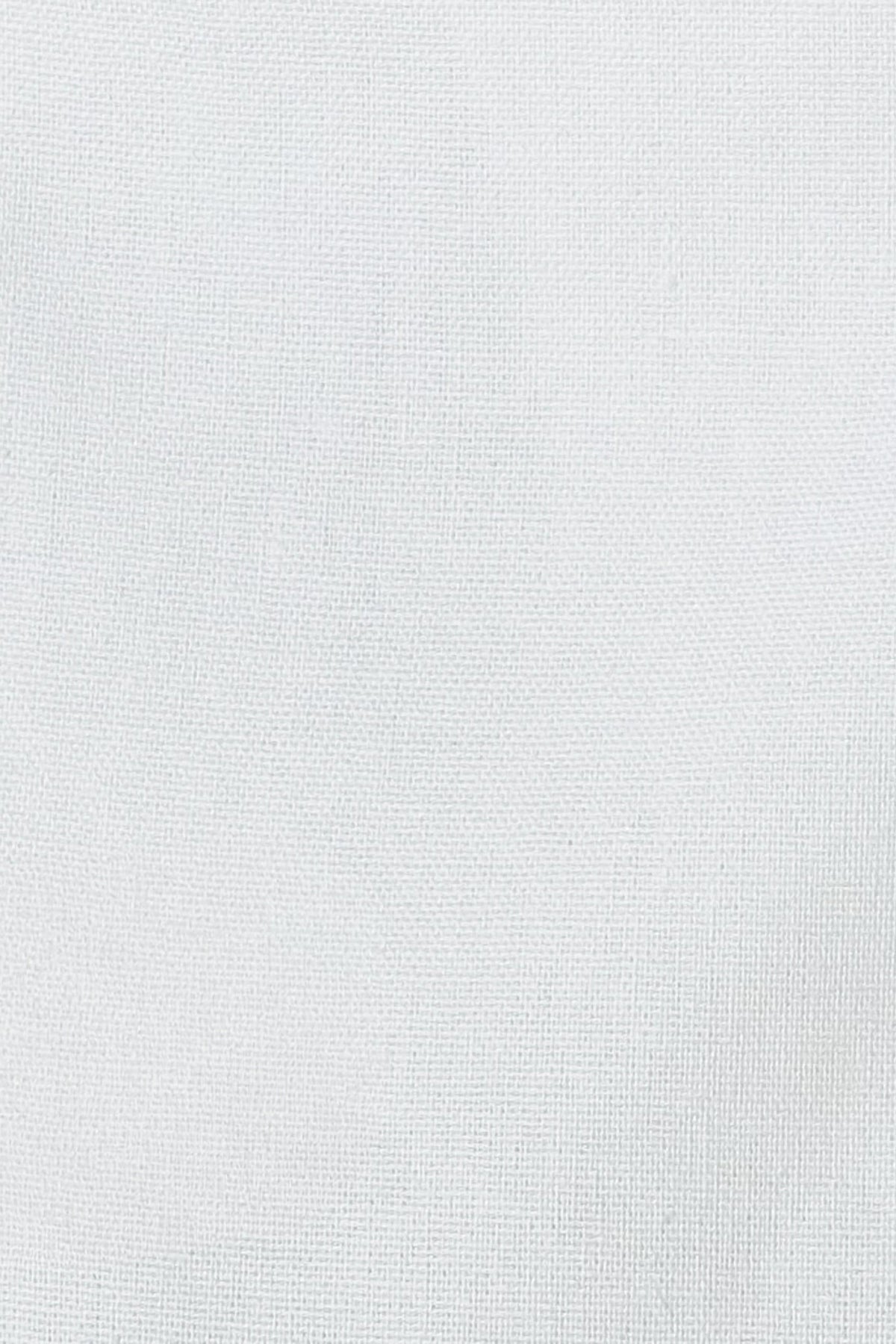 Close-up of White linen cotton fabric showing its natural woven texture
