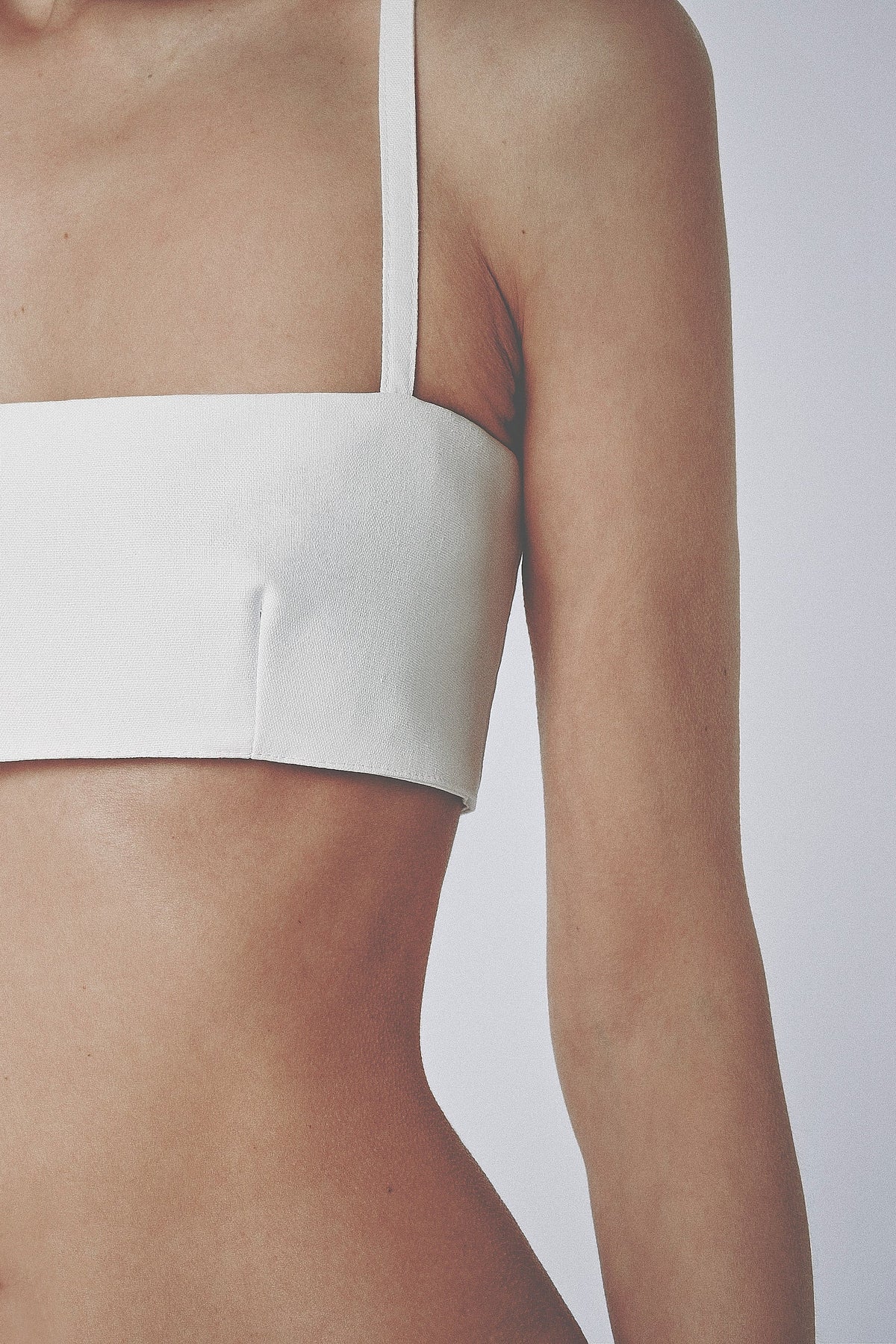 Side view of the White linen cotton crop top showing its close structured fit