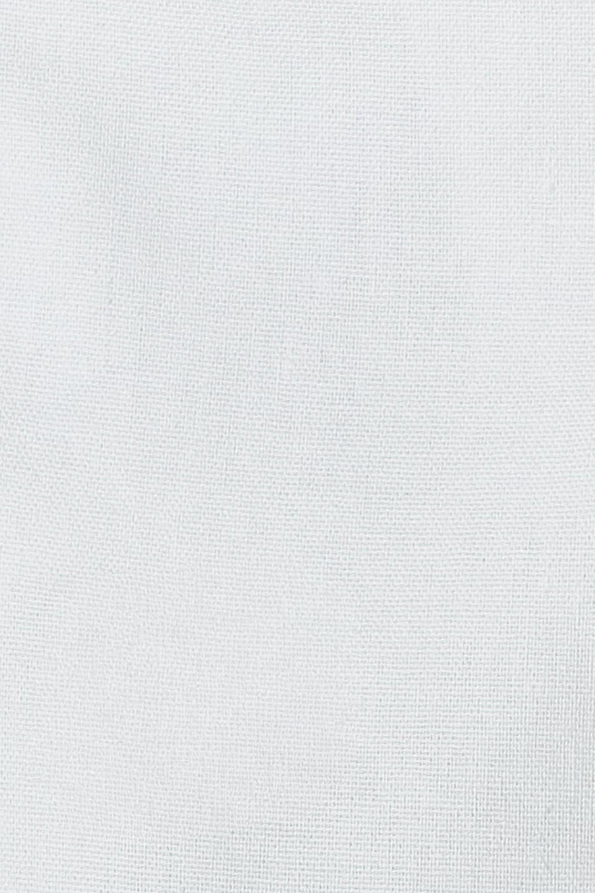 Close-up of White linen cotton fabric showing its natural woven texture
