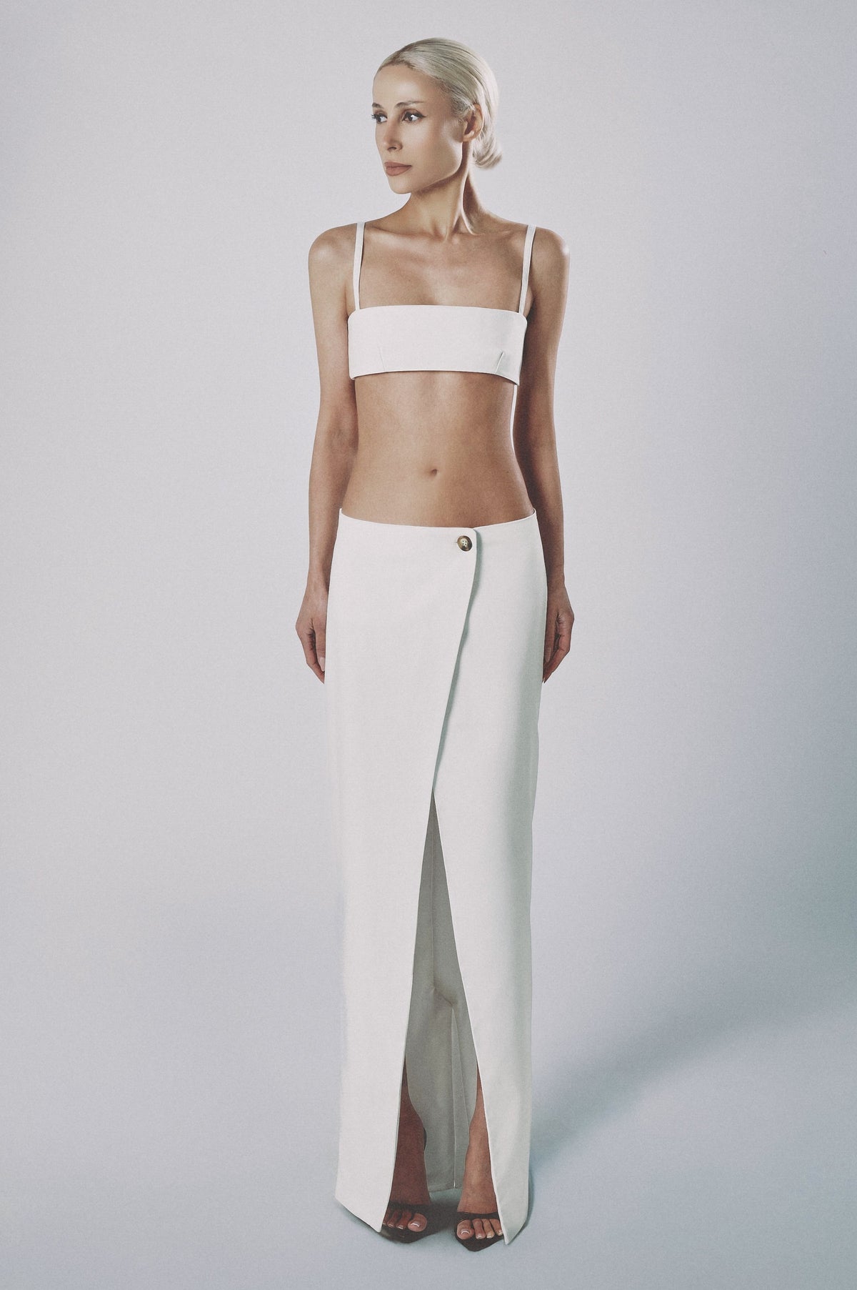 Woman wearing the White linen cotton maxi skirt with matching bra crop top