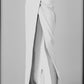 Side view of the White low-rise maxi skirt showing its long straight cut