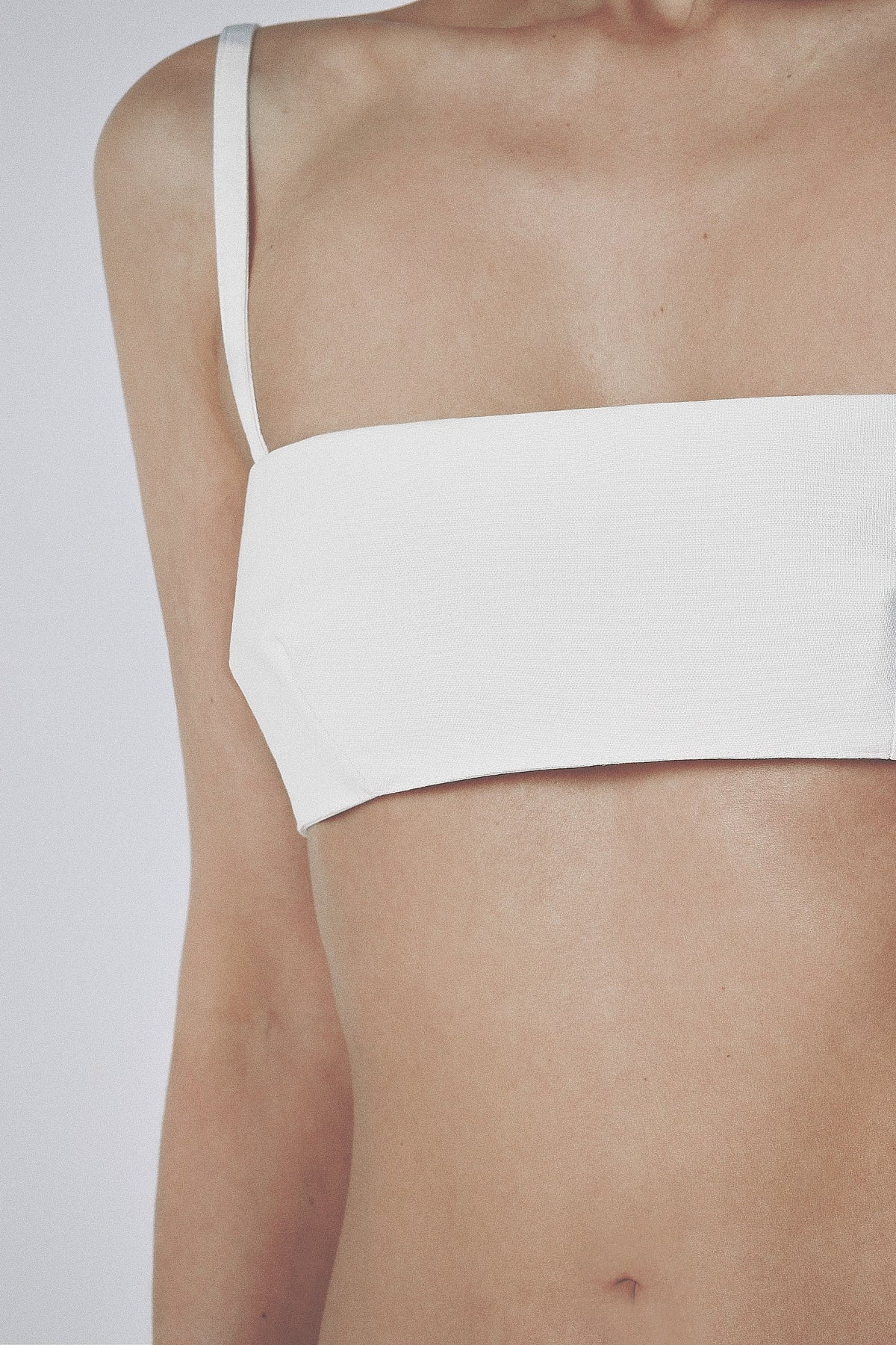 Front view of the White structured bra crop top with slim straps